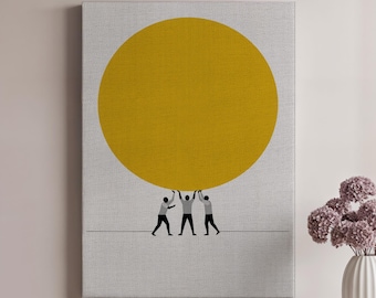 May include: A canvas art print featuring a large yellow circle held up by three silhouetted figures. The figures are standing on a thin gray line against a light gray background. The artwork is displayed on a wall.