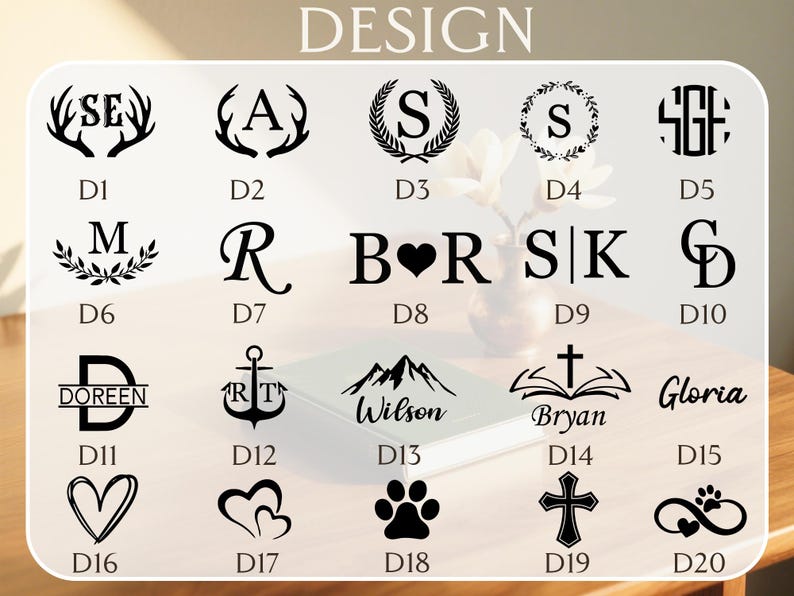 May include: A collection of design options, including initials, monograms, and symbols, displayed on a light wooden surface. The designs are in black and include antlers, wreaths, hearts, and paw prints. The word "DESIGN" is at the top.