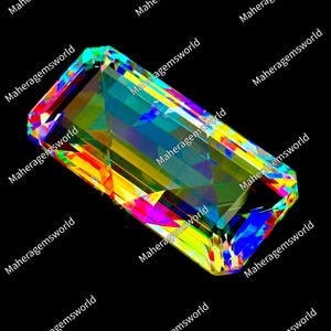 May include: A rectangular faceted gemstone displaying a vibrant spectrum of iridescent colors including yellow, blue, green, and red. The stone features sharp, geometric edges and a highly reflective surface, with the text Maheragemsworld repeated.