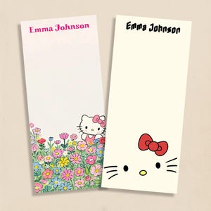 May include: Two personalized notepads. One notepad features a floral design with a Hello Kitty character. The other notepad has a Hello Kitty face with a red bow. Both notepads have the name "Emma Johnson" printed at the top.