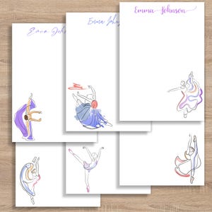May include: White notepads with ballet dancer illustrations in various poses. Each notepad features the name "Emma Johnson" in purple script at the top. The dancer sketches are outlined in black with watercolor accents in shades of purple, blue, and pink.