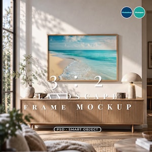 May include: A landscape frame mockup featuring a beach scene with turquoise water and sand. The text 3:2 LANDSCAPE FRAME MOCKUP and PSD SMART OBJECT is visible. The frame is mounted on a wall above a wooden sideboard with a lamp and a plant.