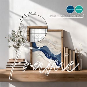 May include: A wooden framed 4x5 ratio mockup with a modern abstract art print. The print features blue and cream tones. The word "FRAME" is written in a cursive font. The mockup is on a wooden shelf with books and plants.