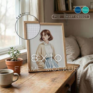 May include: A wooden framed 8x10 inch art print mockup featuring a watercolor illustration of a person in a cardigan and skirt. The frame is on a wooden table with a coffee cup and a potted plant. The text "FRAME MOCKUP" is visible.