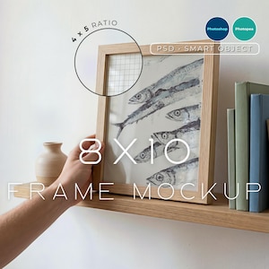May include: A wooden 8x10 inch frame mockup with a fish art print. The frame is held on a wooden shelf with books and a vase. The image includes the text "4 x 5 Ratio", "8 X 10", "Frame Mockup", "PSD - Smart Object".