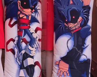 May include: A white rectangular body pillow case featuring a graphic illustration of a dark blue hedgehog character with red glowing eyes, sharp teeth, and red bandages on the left side, and a chained character with a metal muzzle on the right side.
