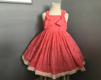 Girls coral dress trimmed with cream eyelet