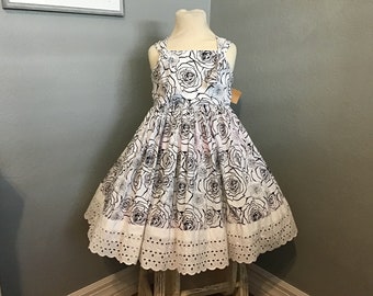 Girls handmade black rose on white fabric dress