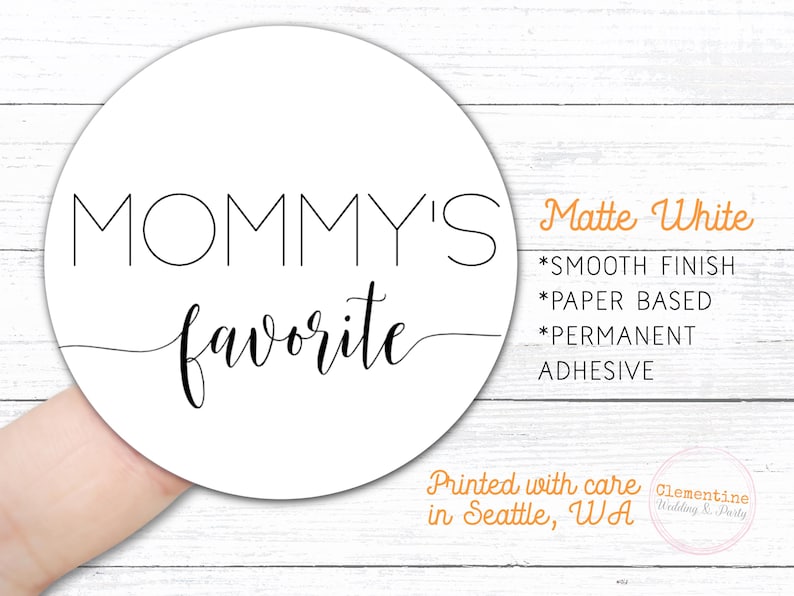 Round label is shown stuck on a fingertip.  Overlay text: ‘Matte White: Smooth finish, paper based, permanent adhesive. Printed with care in Seattle WA by Clementine Wedding & Party.'