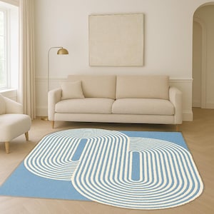 May include: A rectangular light blue rug featuring a geometric pattern of white curved lines. The rug is placed on a wooden floor in front of a beige sofa and armchair. A gold floor lamp and framed artwork are also visible.