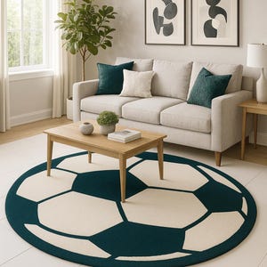 May include: A living room scene featuring a beige sofa with teal and cream-colored throw pillows. A wooden coffee table sits on a round rug designed like a soccer ball. The rug has a cream-colored background with dark teal pentagons.