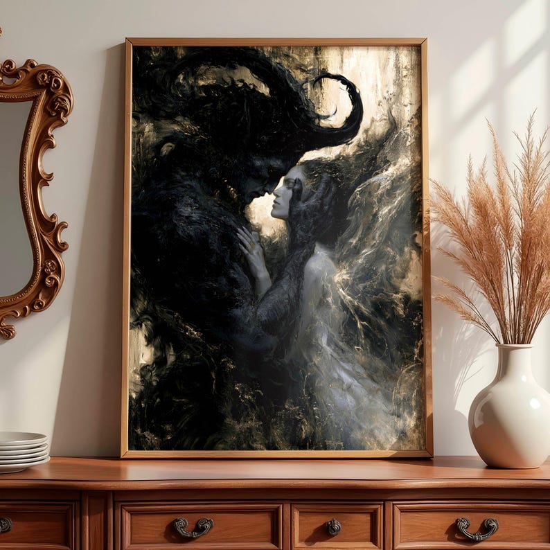 May include: A framed art print depicts a dark, romantic scene. A shadowy figure embraces a woman with flowing hair. The artwork is predominantly black and white with gold accents, creating a dramatic contrast. The print is displayed in a wooden frame.