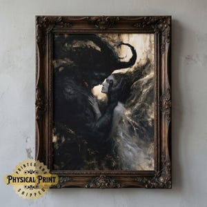 May include: A framed print of a dark, romantic painting. The artwork depicts two figures in a close embrace, one dark and shadowy, the other fair and ethereal. The frame is ornate and dark brown. The print has the text "PRINTED AND PHYSICAL PRINT SHIPPED".