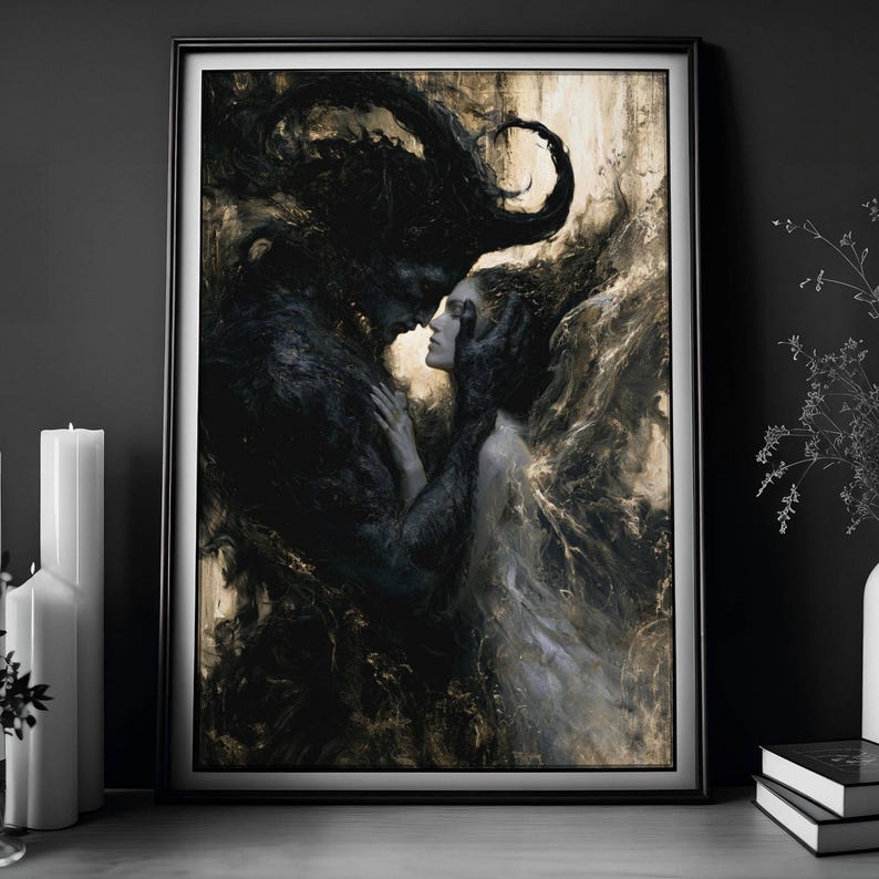 May include: Framed art print depicting a dark, romantic scene. A shadowy figure with large horns embraces a woman. The artwork features a palette of blacks, grays, and gold, creating a dramatic and ethereal atmosphere. The print is in a black frame.