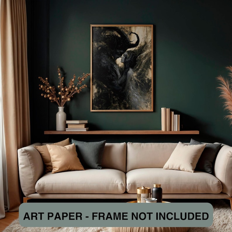 May include: A framed art print featuring a dark, abstract image of two figures. The artwork is predominantly black and white with hints of gold. The print is displayed above a sofa with neutral-toned cushions. Text at the bottom reads: ART PAPER - FRAME NOT INCLUDED.
