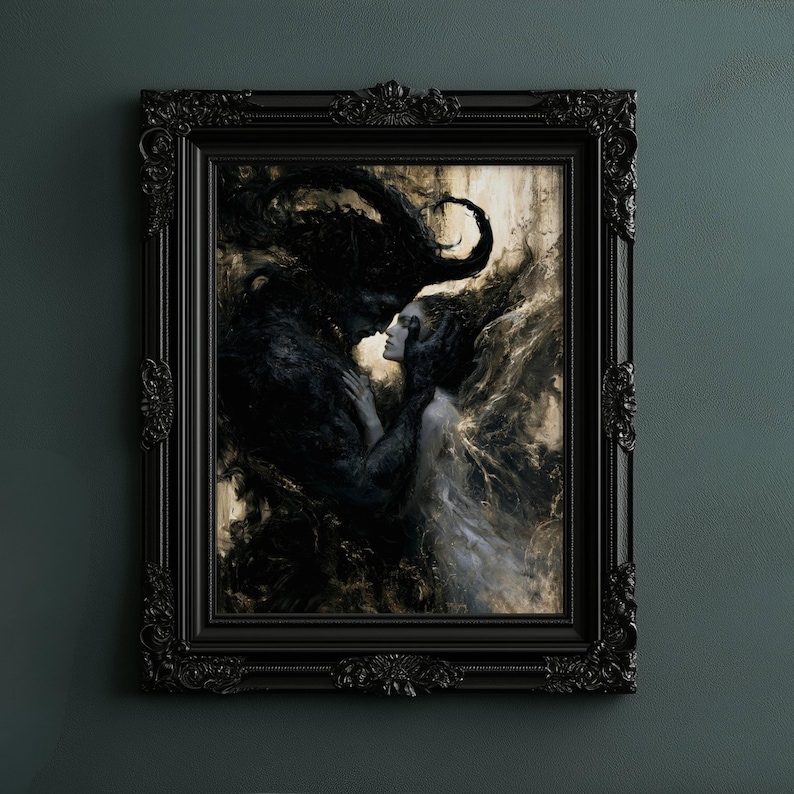 May include: A framed artwork depicting a dark figure embracing a woman. The painting features a palette of blacks, whites, and muted golds, with intricate details and a gothic aesthetic. The black frame has ornate detailing.