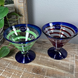 May include: A set of three ceramic mugs with a speckled, matte finish. The mugs are in shades of cream, light gray, and dark gray. Each mug has a simple, minimalist design, perfect for coffee or tea.