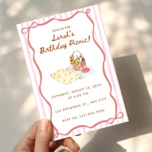 May include: A pink and white striped invitation for Sarah's birthday picnic. The invitation includes the text "Join us for Sarah's Birthday Picnic!" and details for the event, including the date, time, and RSVP information.