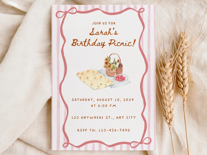 May include: A rectangular invitation with a pink border and vertical stripes. The text reads "Join us for Sarah's Birthday Picnic!" with the date, time, and RSVP information. A watercolor illustration of a picnic basket and food is included.