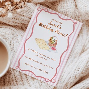 May include: A pink and white striped invitation card for Sarah's Birthday Picnic. The card features a watercolor illustration of picnic food and a basket of flowers. The text includes the date, time, and RSVP information.