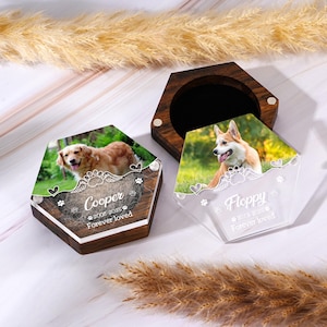May include: Two hexagonal pet memorial boxes with photo inserts. One box features a golden retriever image, the other a corgi. Both have the pet's name, dates, and the phrase "Forever loved."