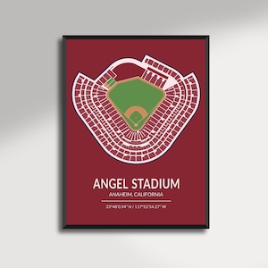May include: A framed print showing a detailed, aerial view of Angel Stadium in Anaheim, California. The stadium is white on a deep red background, with a green baseball field and text that reads "Angel Stadium, Anaheim, California."