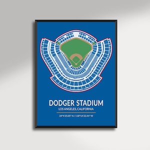 May include: A framed print featuring a detailed, top-down view of Dodger Stadium in Los Angeles, California. The stadium's seating is white, the field is green, and the background is blue. The text "DODGER STADIUM" and coordinates are displayed.