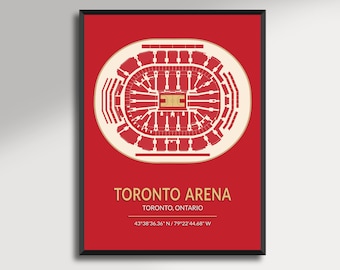May include: A framed print featuring a detailed architectural illustration of the Toronto Arena, rendered in white and gold against a red background. The text "TORONTO ARENA" and coordinates are displayed.