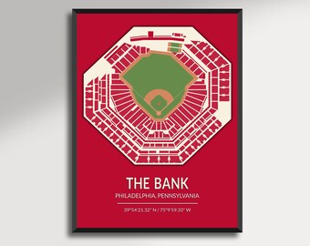 May include: A framed print featuring a detailed, top-down view of a baseball stadium, rendered in white against a red background. The stadium's layout is precise, with seating sections and the field clearly defined. Text at the bottom reads "THE BANK, PHILADELPHIA, PENNSYLVANIA".