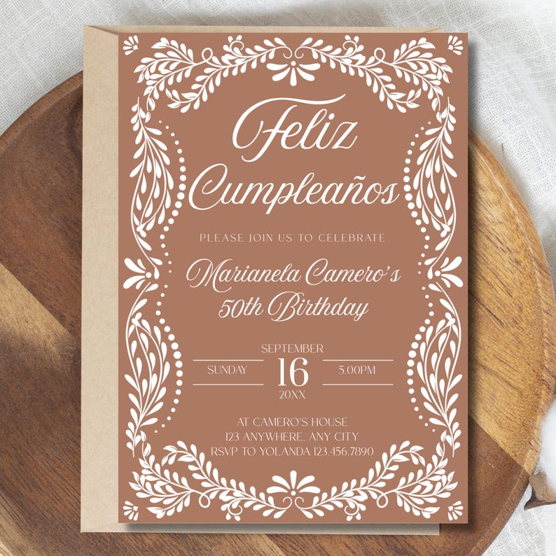 Peut inclure: Une invitation d'anniversaire marron avec une bordure florale blanche et du texte. L'invitation indique "Feliz Cumplea&ntilde;os" et annonce le 50e anniversaire de Marianela Camero le 16 septembre &agrave; 17h00. Comprend les informations RSVP.