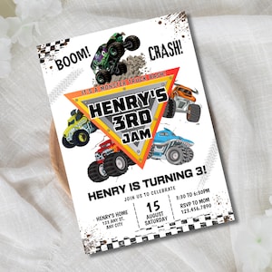 May include: A white invitation card with a monster truck theme. The card features colorful monster truck illustrations, the text "HENRY'S 3RD JAM", and event details. The design includes "BOOM!" and "CRASH!" text elements.