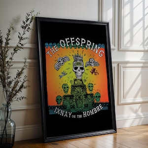 May include: Black framed poster featuring a vibrant illustration with a skull wearing a crown, wings, and the text "THE OFFSPRING". The artwork has a black background with orange and yellow hues, and the text "IXNAY ON THE HOMBRE".