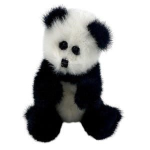 May include: A plush panda toy featuring a white face with black patches around the eyes and black ears. The body is covered in soft, textured black and white fur, with black limbs and a white chest area, designed in a seated position.