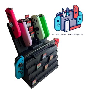 May include: Black Nintendo Switch desktop organizer with slots for game cartridges and controller storage. Includes red, pink, green, and blue controllers. The text "Nintendo Switch Desktop Organizer" is visible.