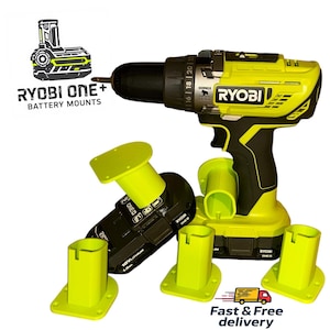 May include: A yellow and black Ryobi drill and battery mounts. The image shows a drill, battery, and several yellow battery mounts. The text "RYOBI ONE+ BATTERY MOUNTS" is visible. The drill has a black handle and a yellow body.