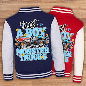 May include: Two letterman jackets, one navy blue and one red. The navy jacket has grey sleeves and the text "just a BOY who loves MONSTER TRUCKS" with monster truck graphics. The red jacket has white sleeves and similar text.