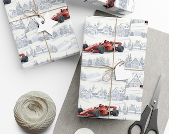 May include: Wrapping paper featuring a repeating pattern of red race cars driving through a snowy village with gray houses and pine trees. The paper is tied with brown twine and includes white star and heart-shaped gift tags.