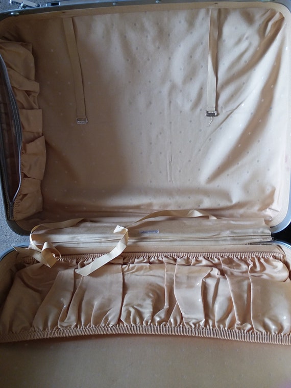 white and tan luggage set