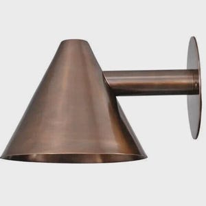 May include: A copper-colored wall sconce with a conical shade and a cylindrical arm extending to a circular mounting plate. The fixture has a modern, minimalist design and is made of metal.