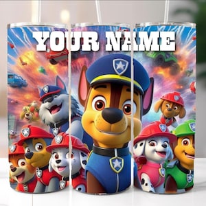 May include: A tumbler featuring the Paw Patrol characters with the text "YOUR NAME" in white. The design includes Chase in a police uniform, and other characters in red and green uniforms. The background has a colorful, action-packed scene.