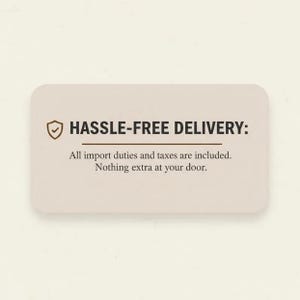 May include: A rectangular beige information card with rounded corners featuring a brown shield icon with a checkmark. The text reads: HASSLE-FREE DELIVERY: All import duties and taxes are included. Nothing extra at your door.