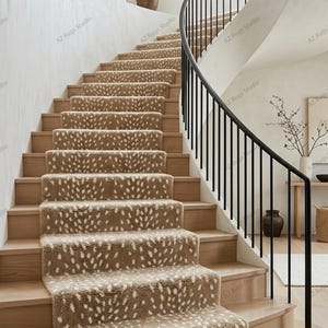 May include: A curved staircase featuring light wood steps covered by a tan carpet runner with a white spotted pattern. The staircase includes a black metal railing and is illuminated by a round paper lantern hanging from the ceiling above.