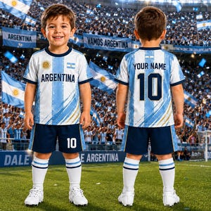 May include: A soccer uniform featuring a white and light blue striped jersey with the text ARGENTINA and a sun emblem on the front, and the text YOUR NAME and the number 10 on the back. The set includes dark blue shorts with the number 10.
