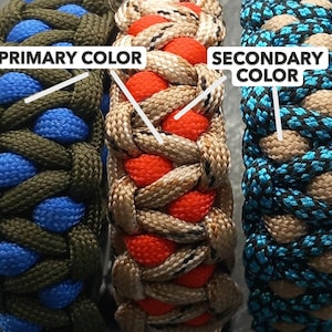 May include: Close-up of three paracord bracelets in various color combinations. One bracelet features olive green and blue, another has tan and red, and the third combines black and teal. The text "PRIMARY COLOR" and "SECONDARY COLOR" are visible.