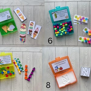 May include: A collection of educational toys for children. Includes a green box with ice cream pieces and cards, a teal box with pom-poms and caterpillar cards, a yellow box with buttons and sticks, and an orange box with sand and letter cards.