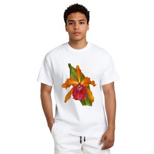 May include: White t-shirt featuring a vibrant floral design. The graphic showcases an orange and red orchid with green leaves. The shirt is a classic crew neck style.