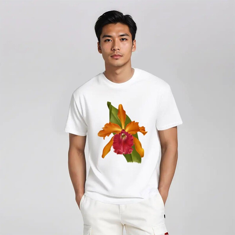 May include: White t-shirt featuring a vibrant orange and red orchid flower design with green leaves. The floral graphic is centered on the front of the short-sleeved tee. The shirt is made of a soft, comfortable material.