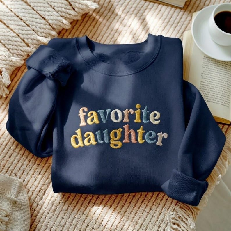 May include: A trio of ceramic mugs with a speckled, matte finish in cream, light grey, and dark grey. Each mug features a simple, minimalist design, ideal for tea or coffee.