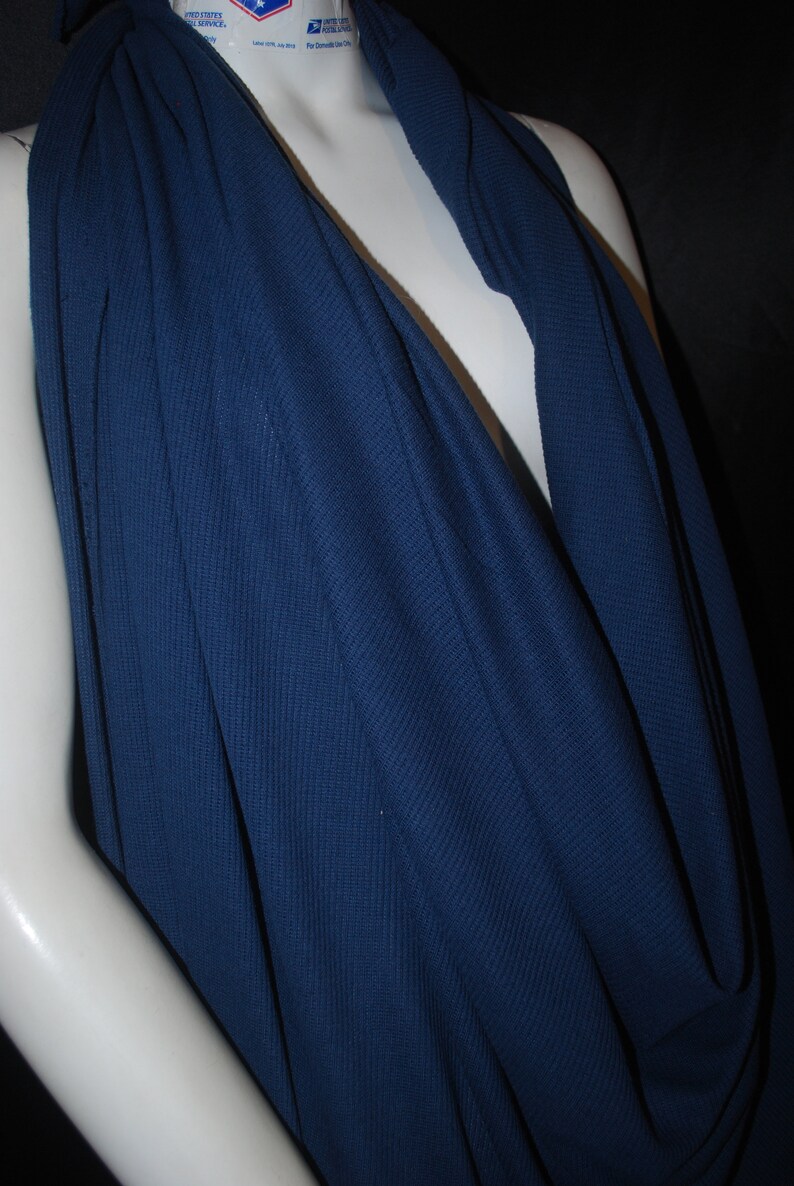 May include: A deep blue, ribbed fabric draped over a mannequin. The fabric is soft and has a slight sheen.