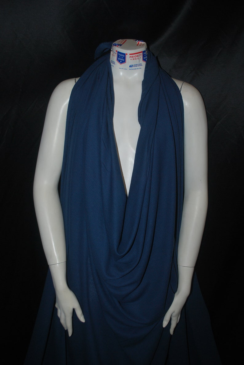 May include: A deep blue fabric draped over a mannequin. The fabric has a textured, waffle-like pattern.